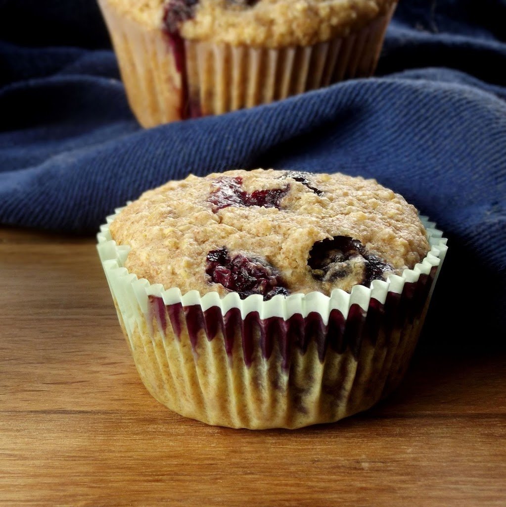 Close Up of a Blueberry Quinoa Muffin with Blue Napkin in the Background