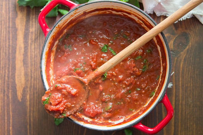 Pot of Marinara Sauce with Wooden Spoon Perched on Top