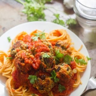 Eggplant Meatballs and Tomato Sauce Over Spaghetti on a Plate