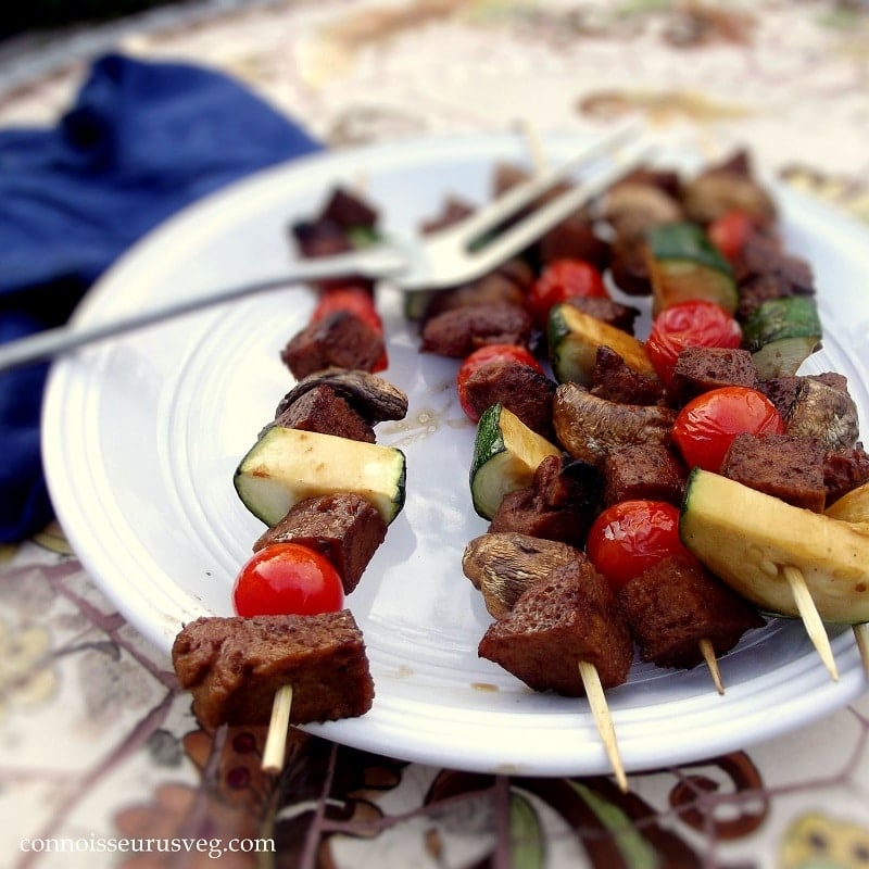 Close Up of Veggie Seitan Kebabs on a Plate with Grilling Fork