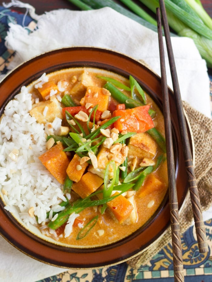 Overhead View of a Bowl of Thai Massaman Curry with Sweet Potatoes and Tofu with Rice and Chopsticks