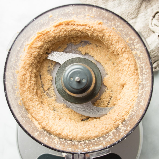 Food Processor Bowl Filled with Paste Made of Blended Hazelnuts