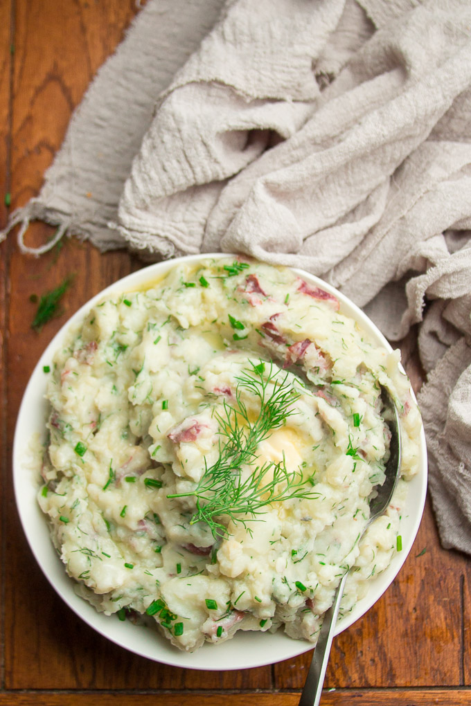 Mashed Red Potatoes with Roasted Garlic & Dill in a Bowl on Wooden Table with Napkin