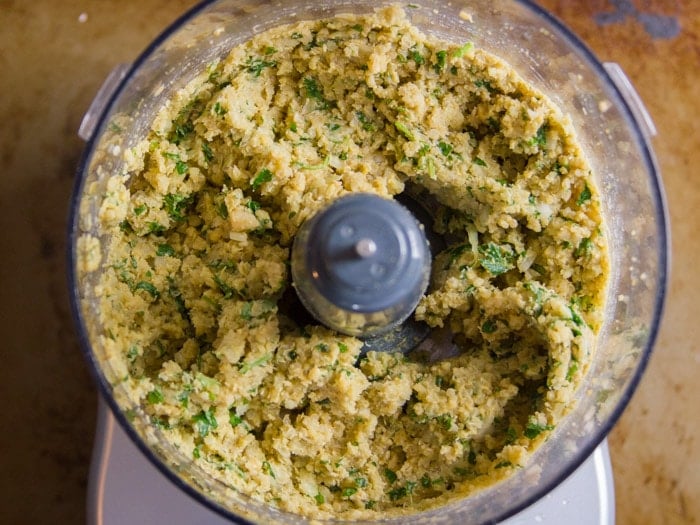 Food Processor Bowl Filled with Ingredients for Making Quinoa Falafel