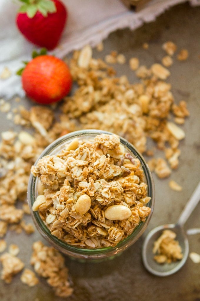 Overhead View of a Jar of Peanut Butter Granola with Strawberries and Spoon