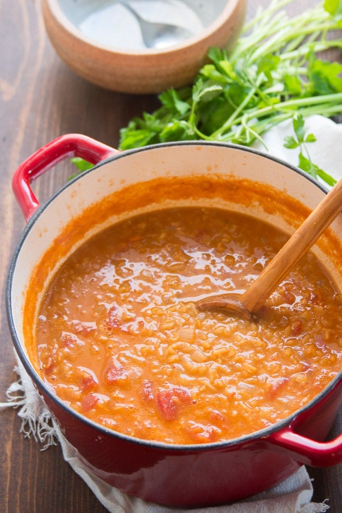 Mediterranean Red Lentil Soup in a Pot with Wooden Spoon.