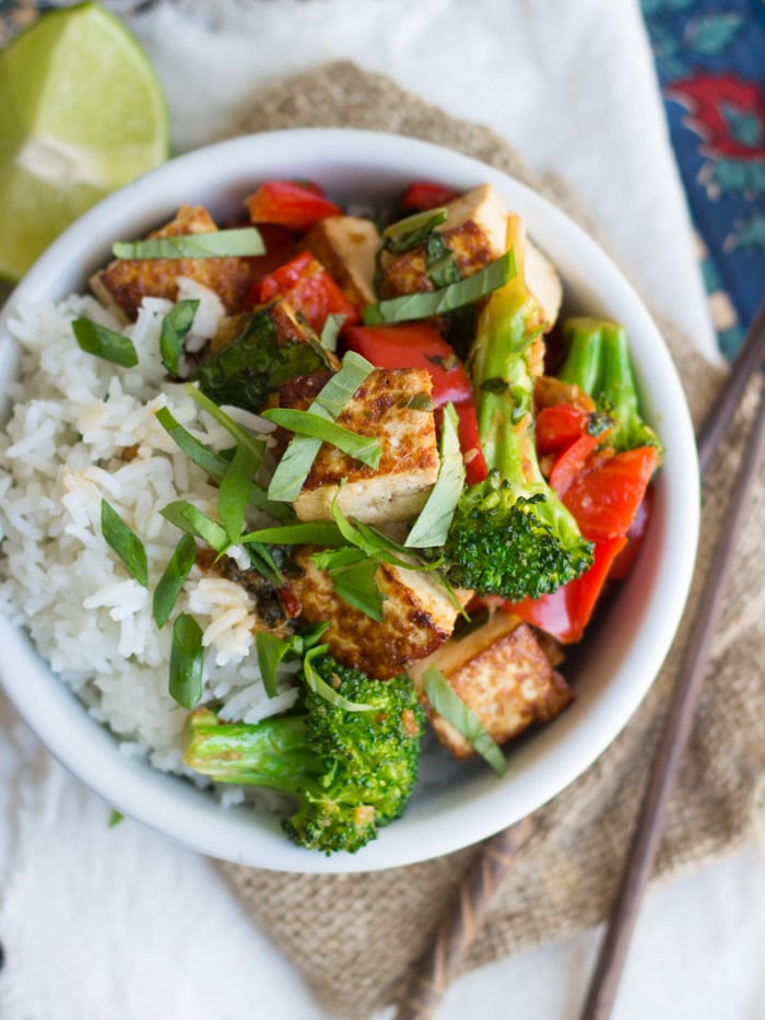 Overhead View of a Bowl of Thai Basil Tofu Stir Fry and Rice, with Chopsticks on the Side