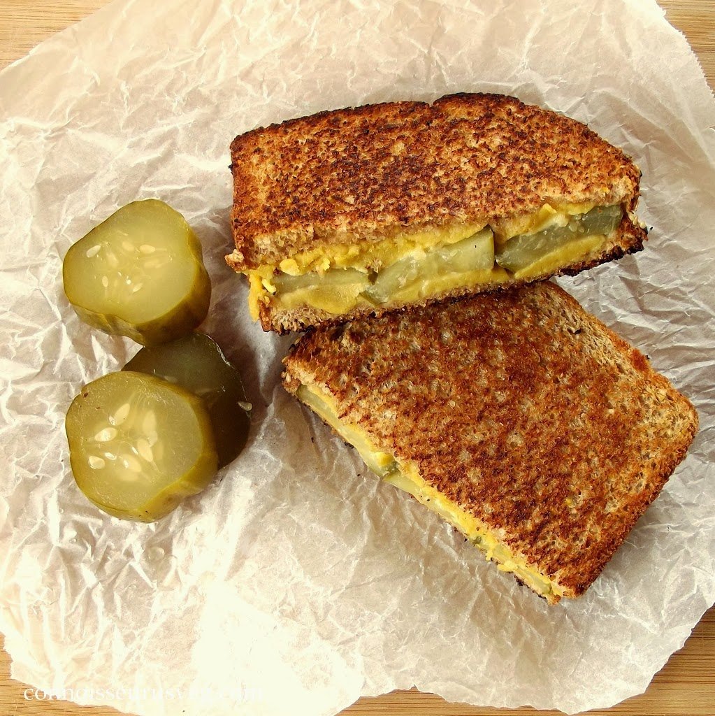 Two Halves of a Dill Pickle Grilled Cheese Sandwich and a Pickle, Cut in Half