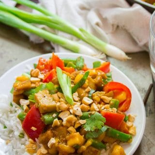 Vegan Mango Chicken Stir-Fry on a Plate with Skillet in the Background