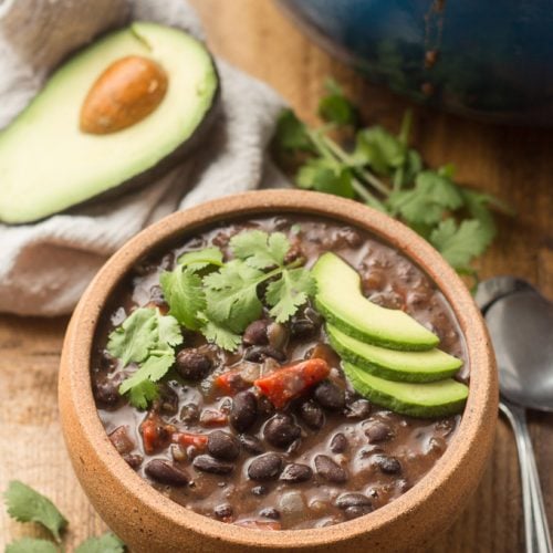 Spicy Black Bean Soup with Pot, Cilantro, Napkin and Avocado Half in the Background