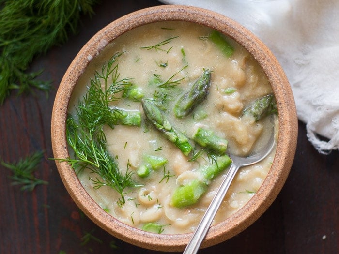 Overhead View of a Bowl of Creamy White Bean Asparagus & Dill Soup with Dill Sprigs on Top