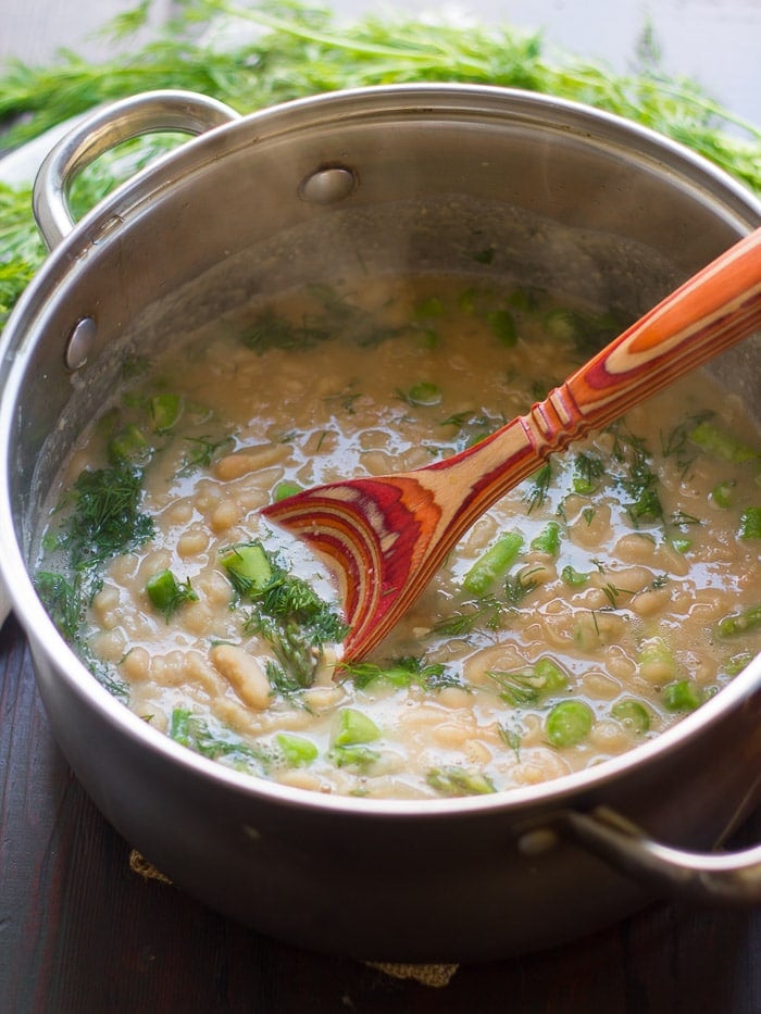 Pot of Creamy White Bean Asparagus & Dill Soup with Wooden Spoon