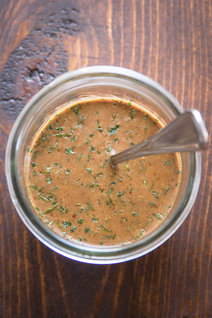 Jar of Herbed Balsamic Vinaigrette with a Spoon