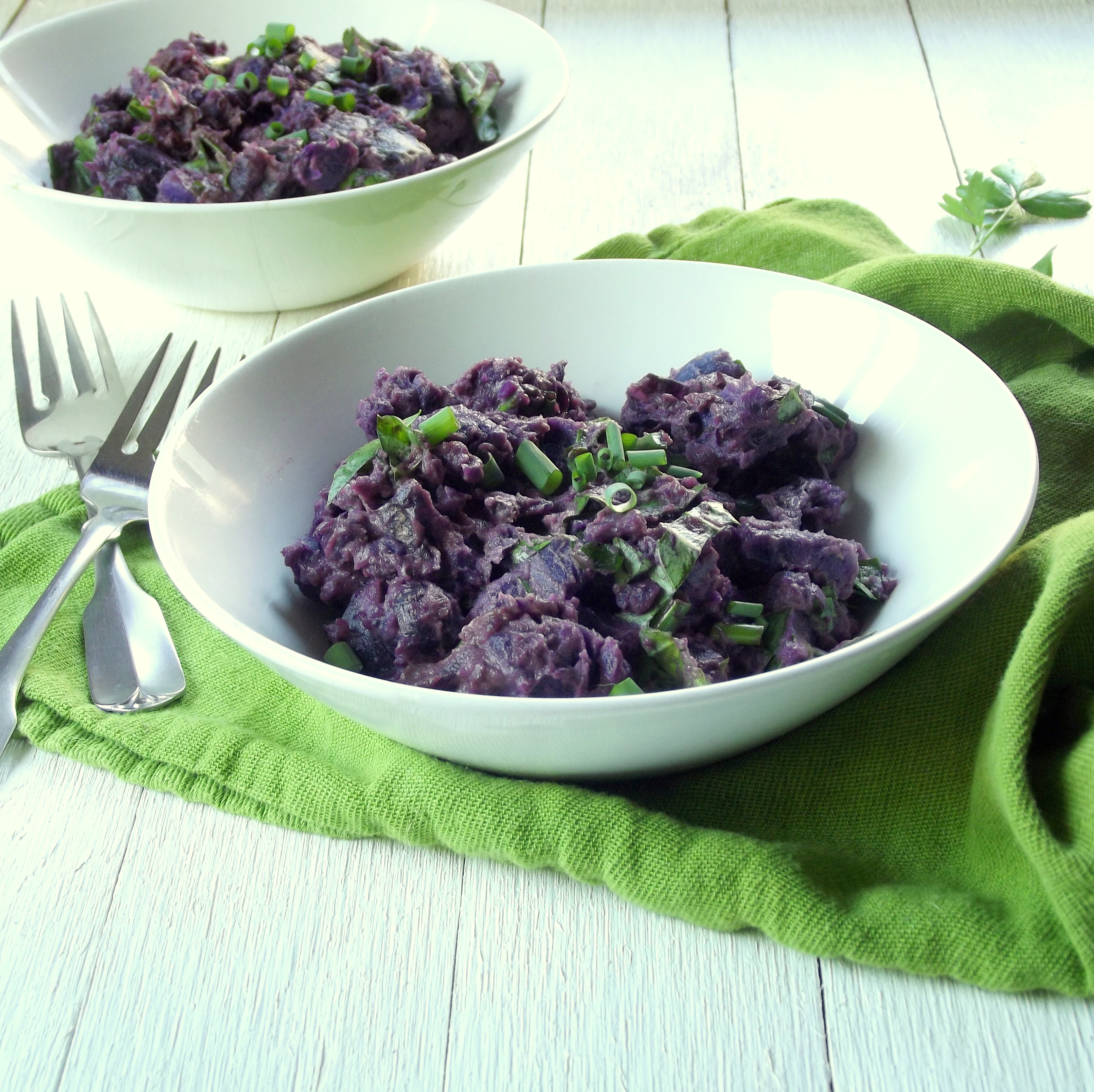 Two Bowls of Purple Potato Salad with Forks on the Side