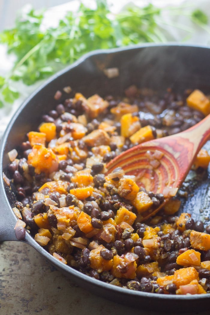 Butternut Squash & Black Beans in a Skillet with Wooden Spoon