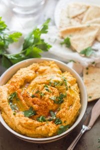 Bowl of Butternut Squash Hummus with Pita Wedges and Parsley in the Background