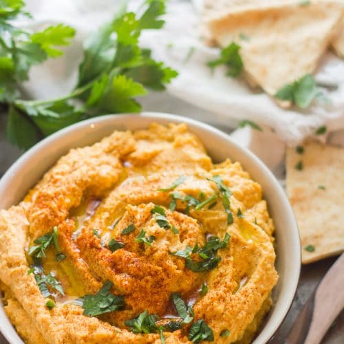 Bowl of Butternut Squash Hummus with Pita Wedges and Parsley in the Background