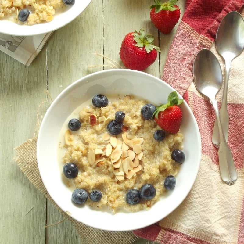 Bowl of quinoa porridge with berries on top.