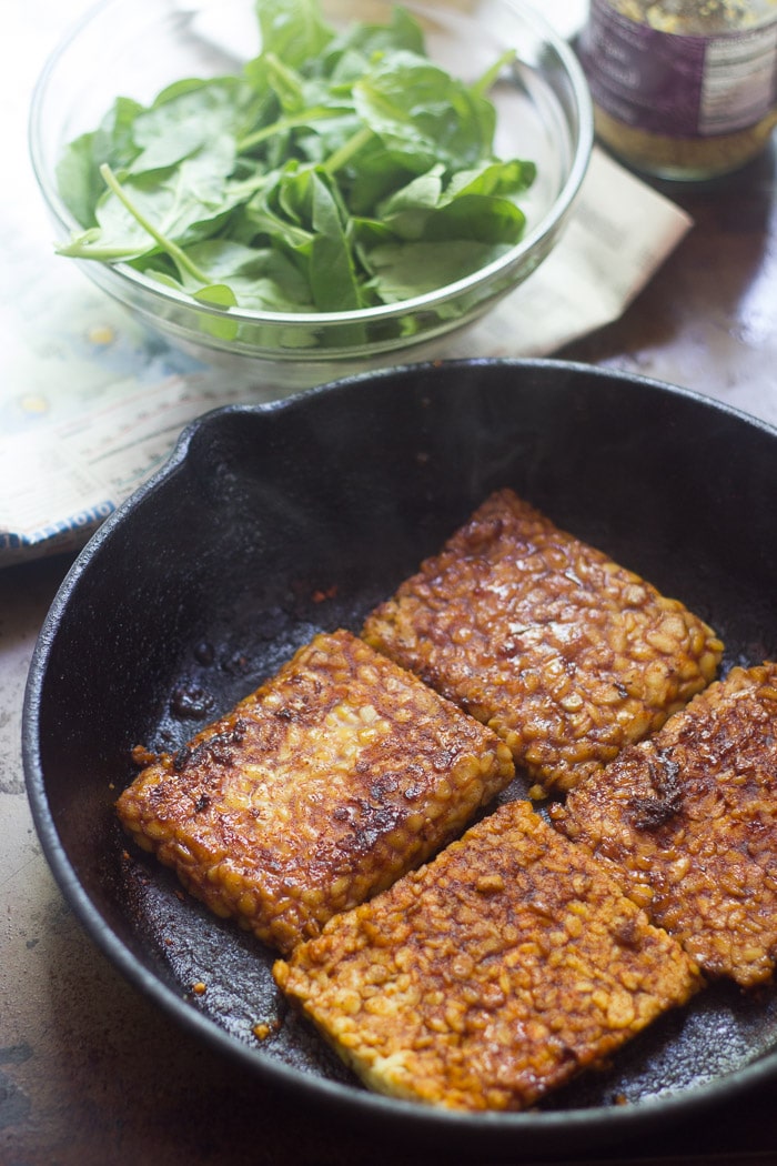 Four Slabs of Marinated Tempeh in a Skillet