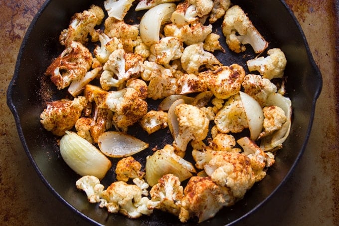Skillet Filled with Roasted Cauliflower, Garlic and Onions for Making Blackened Cauliflower Soup