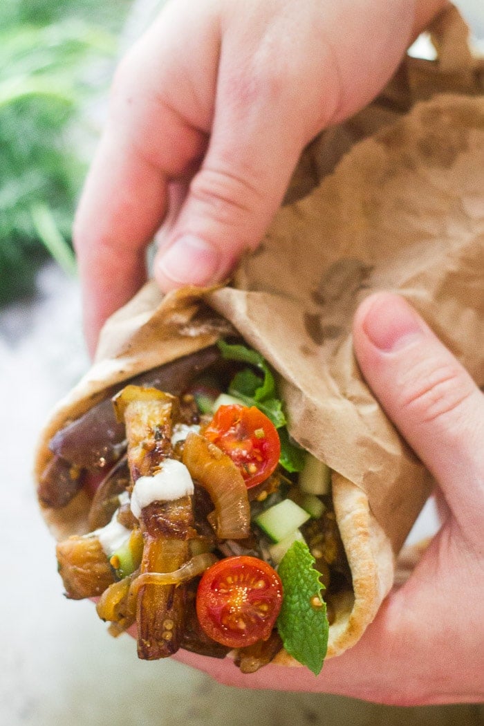Pair of Hands Holding an Eggplant Gyro