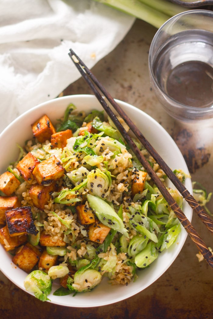 Brussels Sprout Fried Rice with Spicy Baked Tofu in a Bowl with Chopsticks