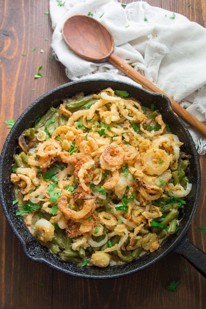 Skillet of Vegan Green Bean Casserole with Wooden Serving Spoon and Napkin