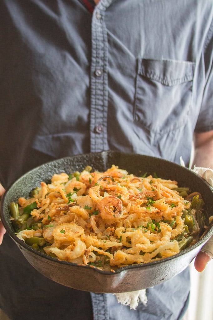 Hands Holding a Skillet of Vegan Green Bean Casserole