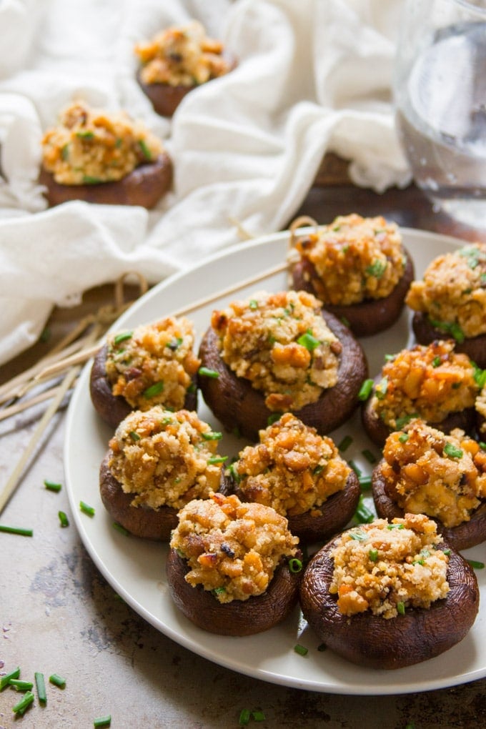 Vegan Stuffed Mushrooms on a Plate with Napkin and Toothpicks in the Background