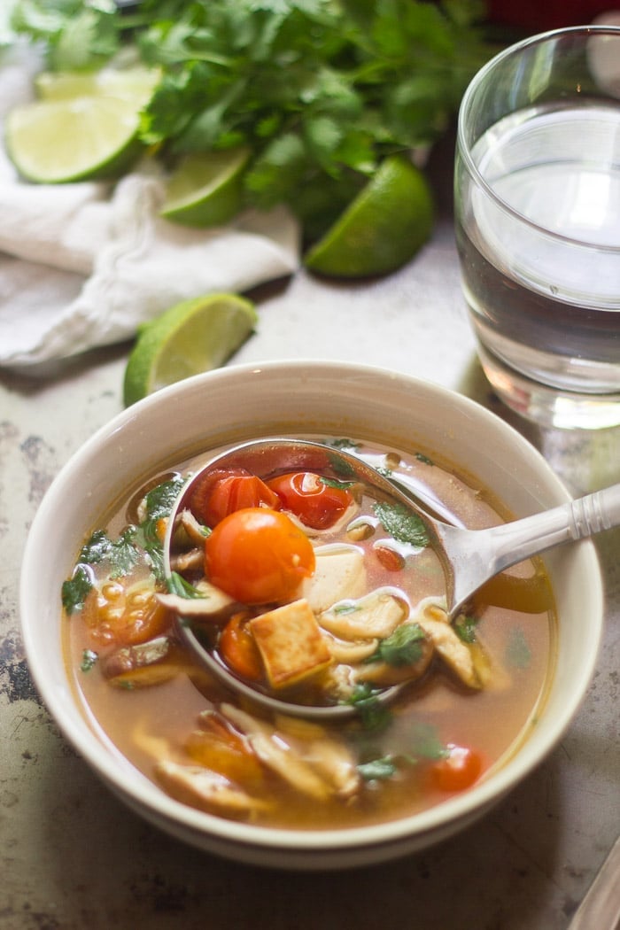 Ladle Placing Thai Lemongrass Soup into a Bowl