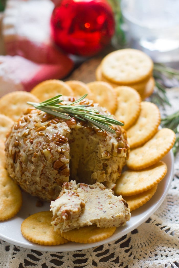 Maple Dijon Vegan Cheese Ball on a Plate with Crackers and Rosemary