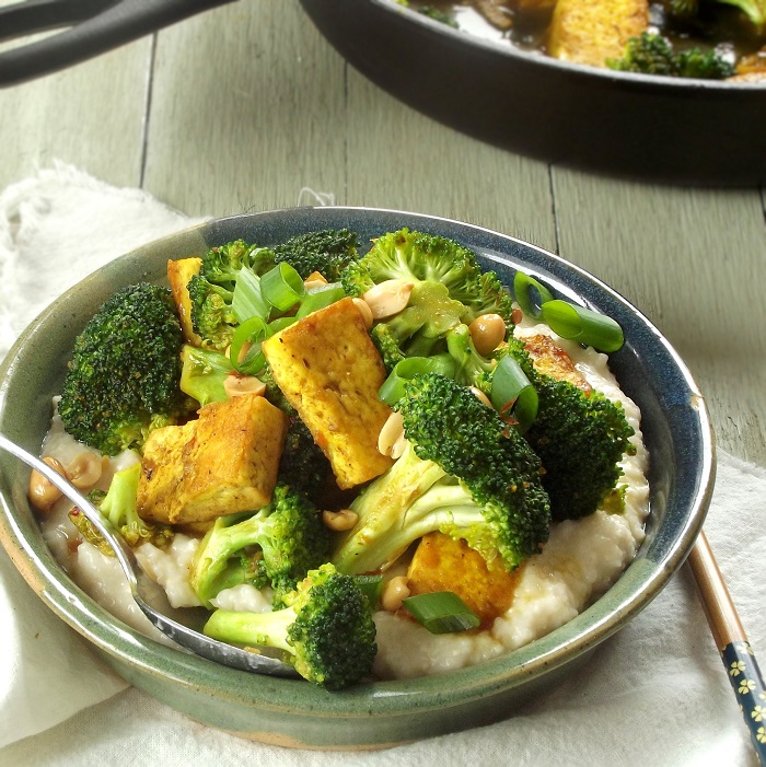 Bowl of Malaysian Tofu & Broccoli Curry Over Grits, Skillet in the Background