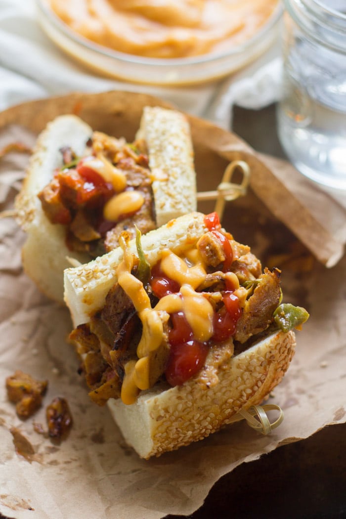 Vegan Philly Cheesesteak Sandwich Cut in Half on Deli Paper
