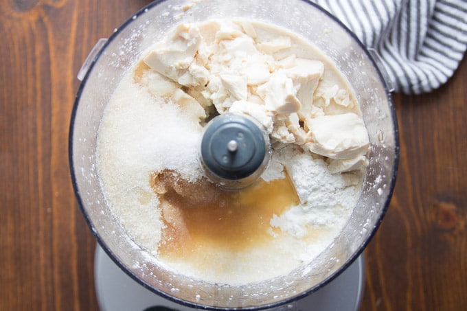 Food Processor Bowl Filled with Ingredients for Making Vegan Cheesecake Batter