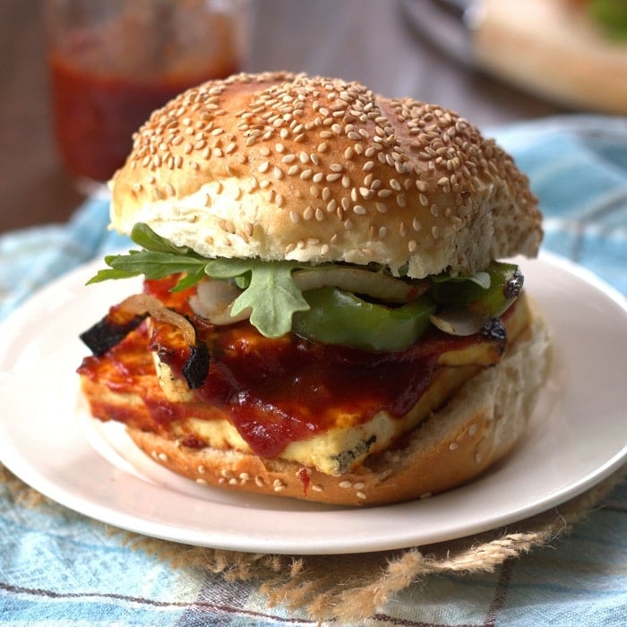 Close Up of a Barbecue Tofu Sandwich on a Sesame Seed Bun