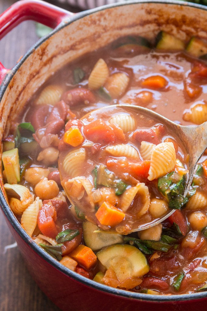 Ladle Drawing Vegan Minestrone Soup from a Pot