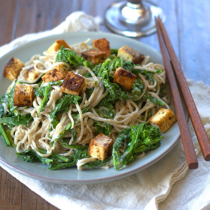 Plate of Tahini Soba Noodles with Tofu and Greens, Chopsticks Perched on the Side