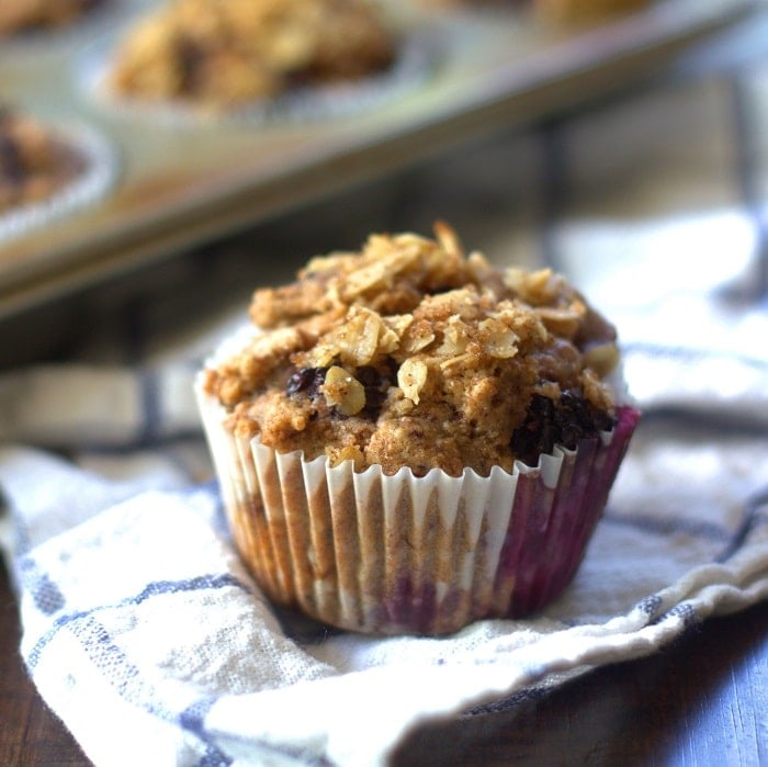 Close Up of a Vegan Blackberry Muffin with Muffin Tin in Background