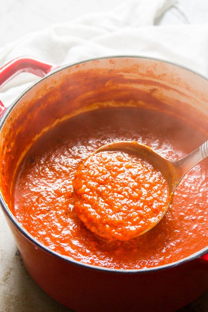 Ladle Scooping Roasted Red Pepper Soup from a Pot
