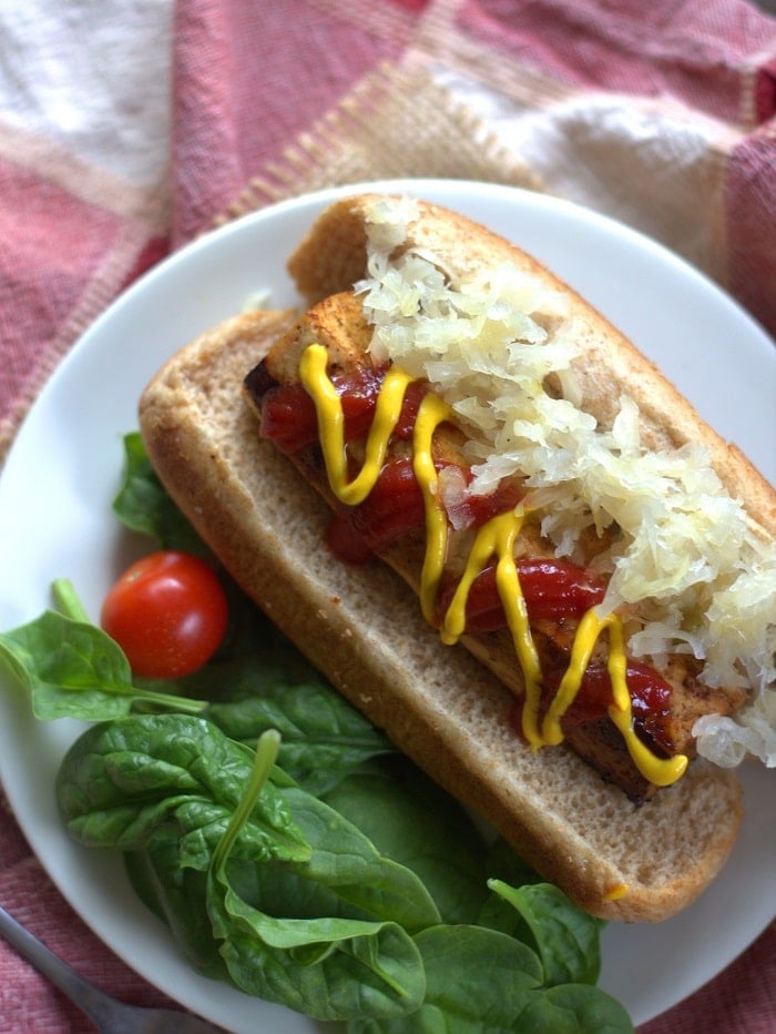 Overhead View of a Tofu Frank on a Bun with Ketchup, Mustard, and Sauerkraut