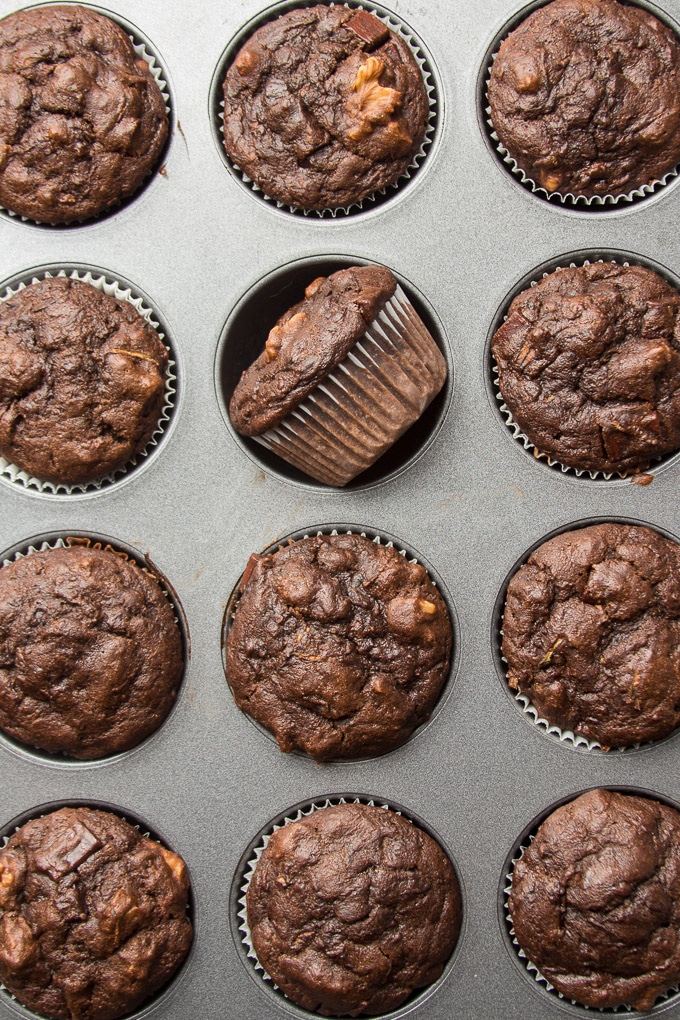 Vegan Chocolate Zucchini Muffins in a Muffin Tin, One Muffin Turned on Its Side