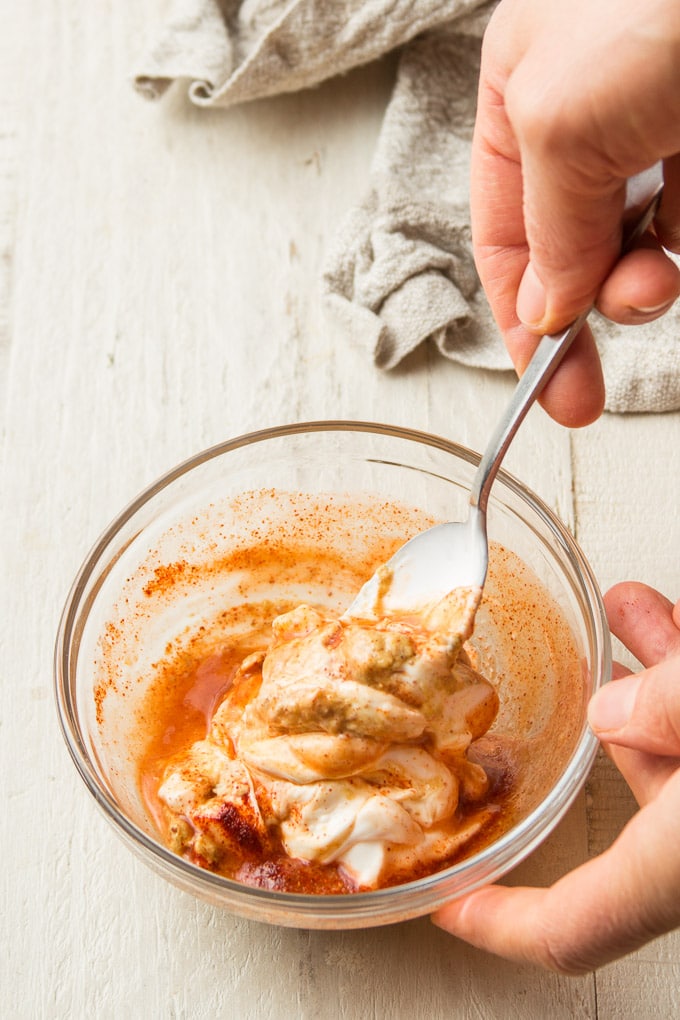 Hand Stirring Vegan Remoulade Sauce Together in a Bowl