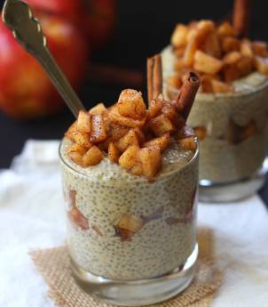 Two Peanut Butter Apple Chia Parfaits with an Apple in the Background