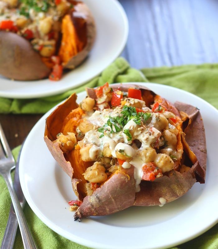 Chickpea Stuffed Sweet Potato on a Plate with Fork on the Side