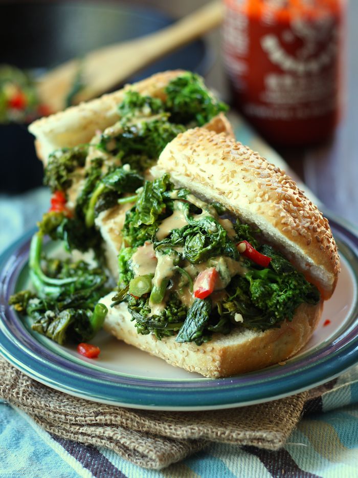 Close Up of Two Halves of a Broccoli Rabe Sandwich on a Plate
