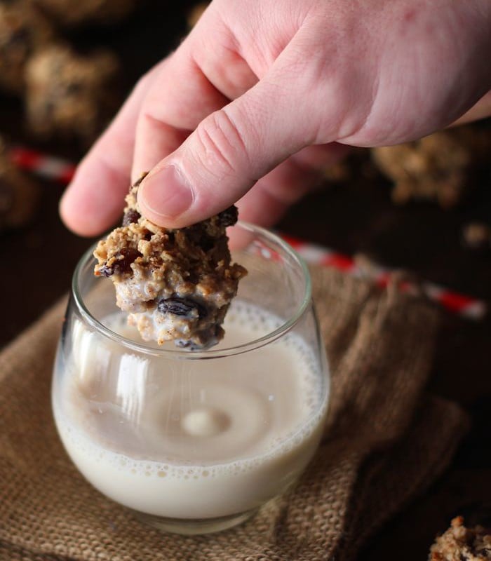 Hand Dipping a Chocolate Chip Cookie into a Glass of Milk