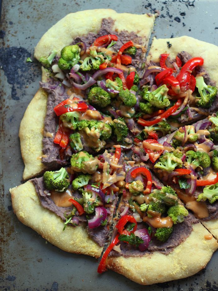 Sliced Vegan Mexican Pizza on a Distressed Metal Surface