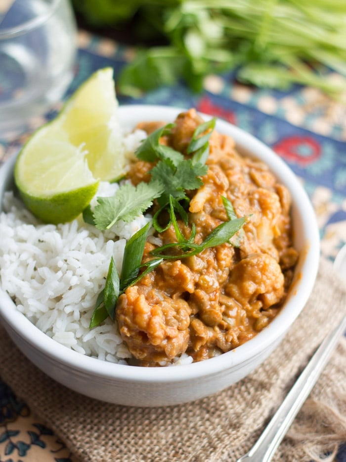 Bowl of Cauliflower & Lentil Curry with Rice, Lime Wedges, Scallions and Fresh Cilantro