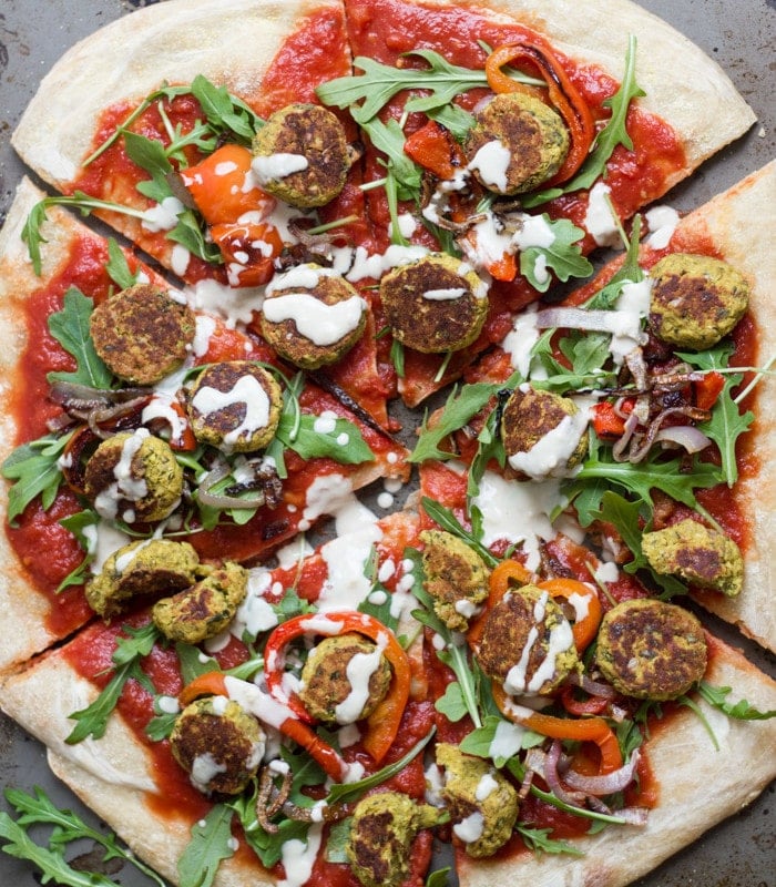 A Whole Falafel Pizza on a Distressed Background