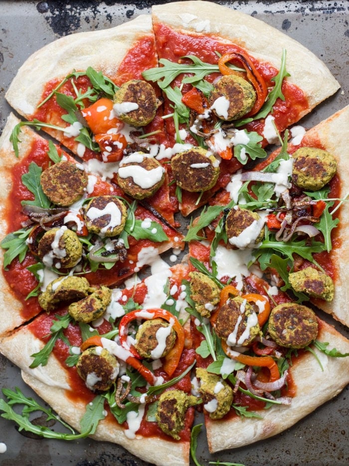 A Whole Falafel Pizza on a Distressed Background